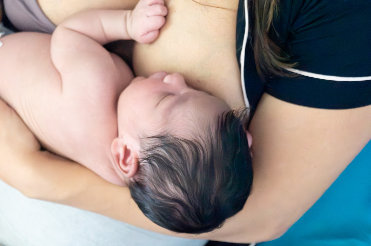 A person is holding a baby in their arms