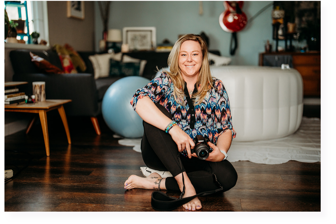 a person sitting on the floor holding a camera