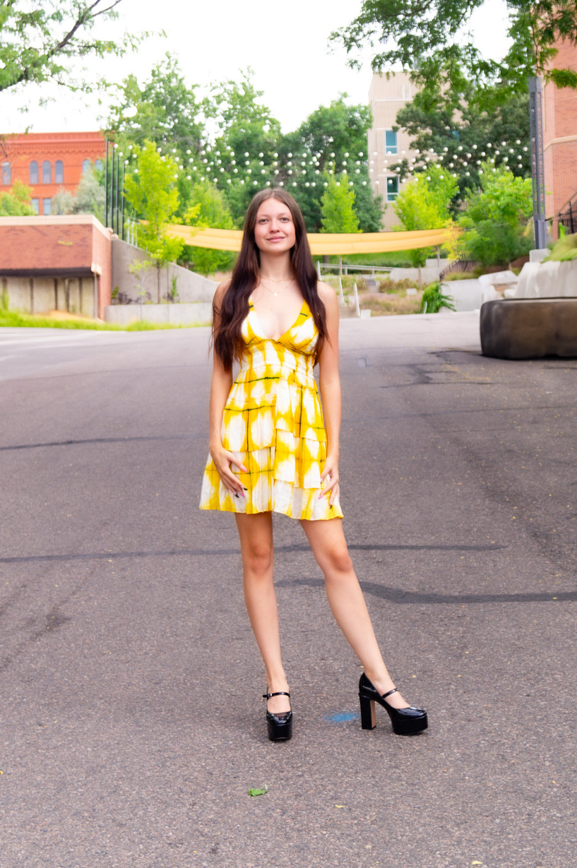 a person in a yellow dress posing for a picture