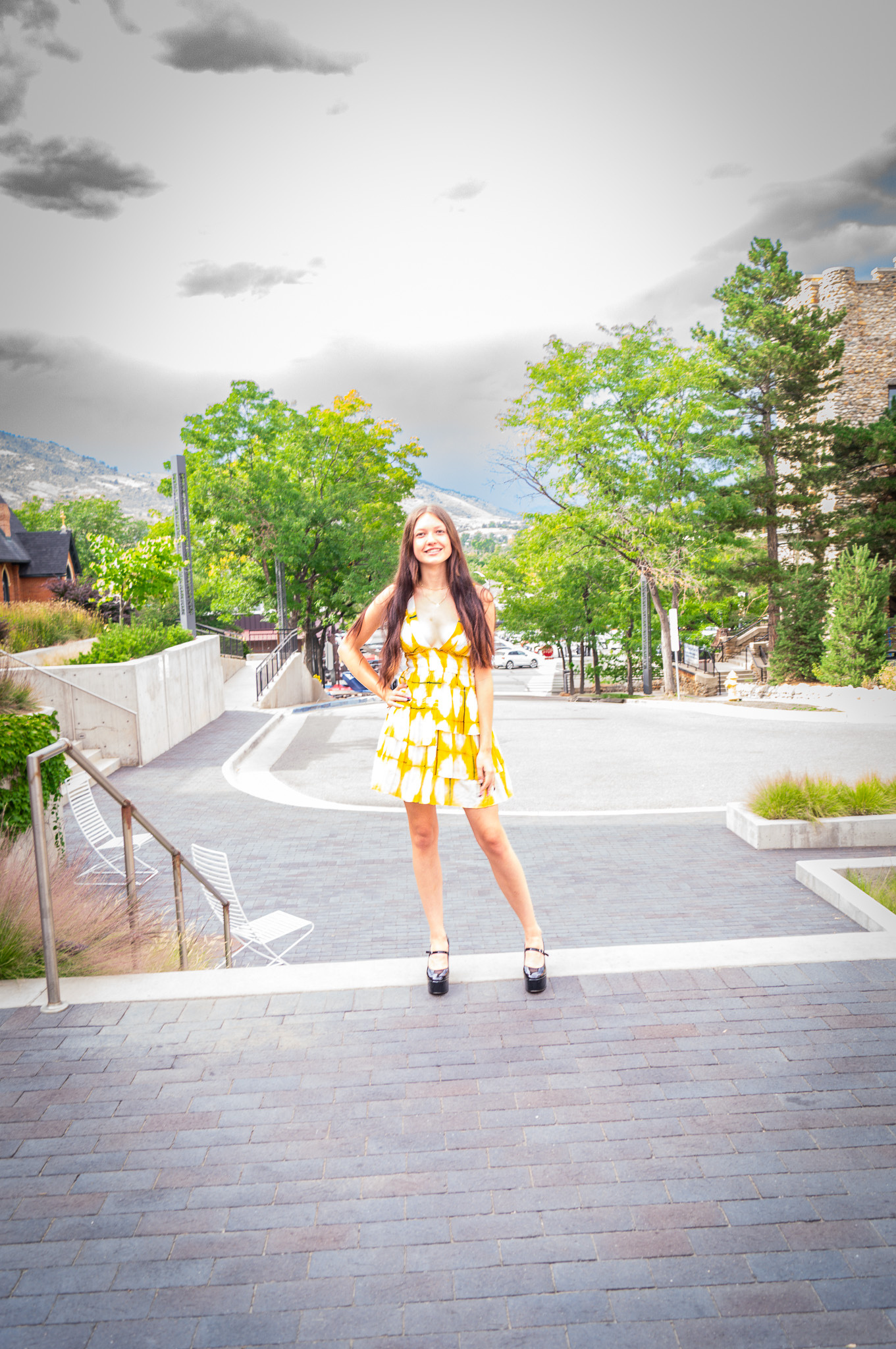 a person in a yellow dress standing on some steps